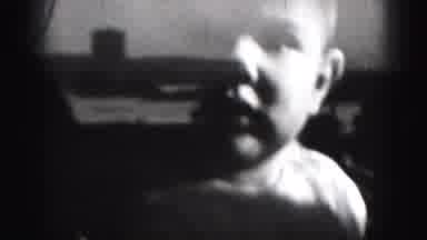 Harrisburg Penn (1946): Baby Wearing White Shirt Looks At Camera On A Sunny Day