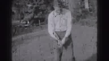 HARRISBURG PENN-1946: Man Plays Golf On Grass Course With Vintage Car In Background