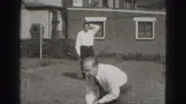 Harrisburg Penn (1946): People Standing In The Front Yard As One Man Leans Down