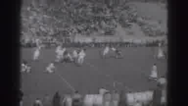 Harrisburg Penn (1946): A Marching Band Performs In A Stadium As People Watch From