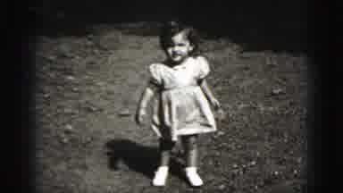 New Cumberland Penn (1946): Toddler Wearing White Dress Walks Towards Camera On A