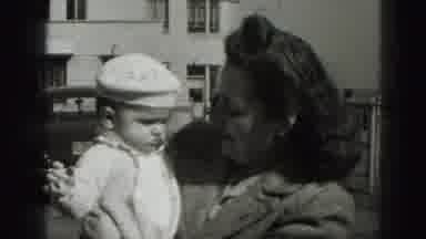 New Cumberland Penn-1946: Mother Holding Baby In 1940s Urban Setting
