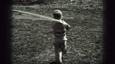 New Cumberland Penn (1946): Young Boy Tugging On Rope Turning To Look At Camera On
