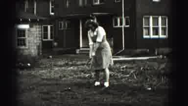 New Cumberland Penn (1946): Man Holding A Golf Club And A Girl In Dress Swinging