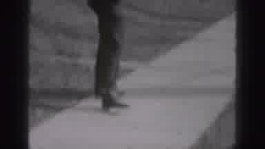 New Cumberland Penn (1946): Man Wearing Black Suits Walks Down Sidewalk On A Sunny