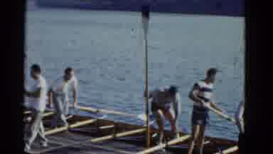 Boston Mass (1951): Men Collecting Scull Oars From Water While Others Jog On A