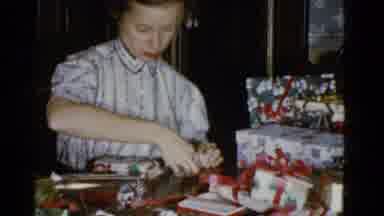 Boston Mass (1951): Female Wrapping Presents On Table With A Pile Of Presents