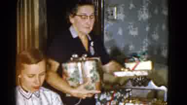 Boston Mass (1951): Woman Wearing Black Dress Places Wrapped Gift Boxes On Table