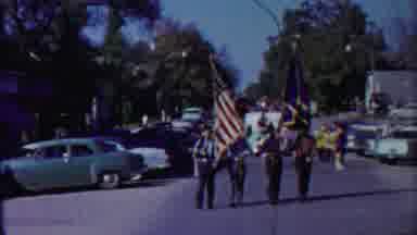 Cheyenne County Kansas (1958): Men Carry Flags Down Street In March
