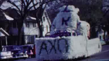 Cheyenne County Kansas (1958): A Vehicle Full Of Flowers Are Moving In the City On