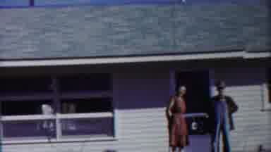 Cheyenne County Kansas (1958): A Man And The Lady Are Standing Outside The