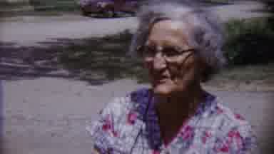 Saint Francis Kansas (1958): Boy Wearing White Sits On Grass Smiling At Camera On