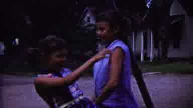 Saint Francis Kansas (1958): Two Girls Play Fighting With A Fly Swatter In Front