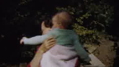 Saint Francis Kansas (1958): Woman Holding A Baby As She Smiles And Dances In A