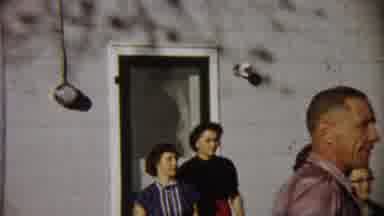 Saint Francis Kansas (1958): Woman Wearing Black Skirt Walks Down Stairs Of A