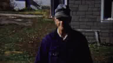Chadron Nebraska (1959): Man Wearing Grey Hat Walks Toward Camera On A Sunny Day