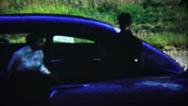 Chadron Nebraska (1959): Two People Exiting A Blue Car