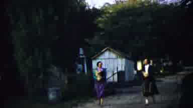 Chadron Nebraska (1959): Two Amish People Walking With Bag In Arms