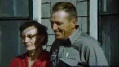 Chadron Nebraska (1959): Vintage Couple Standing In Front Of A House Smiling
