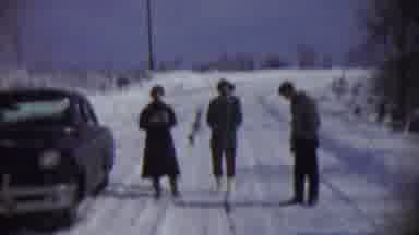 Chadron Nebraska (1959): Two People And A Man Lighting A Cigarette Standing In The