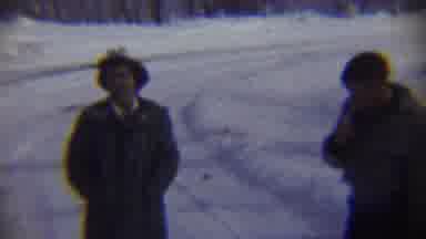 Chadron Nebraska (1959): Man Wearing Tan Jacket Smokes Cigarette On A Cloudy