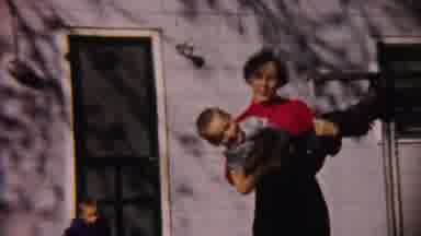 Cheyenne County Kansas (1959): A Mother Was Holding The Child And Plays With The