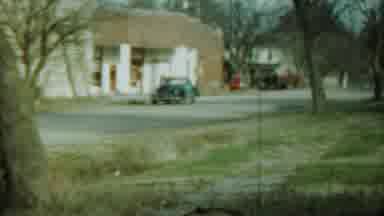 Saint Francis Kansas (1959): Zoom Of An Old Blue Car Near A House