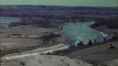 Saint Francis Kansas (1959): View Of Lake And Tan Concrete Column On A Sunny Day