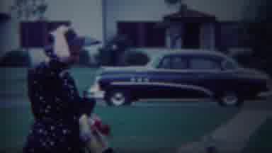 South Bend Indiana (1958): Woman Secures Her Hat Not To Be Blown Away