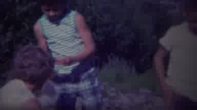 Yellowstone Wyoming (1967): Toddler Wearing White Shirt Waves Hand In Air On A