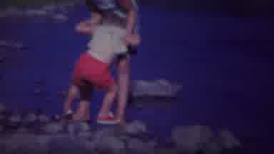 Yellowstone Wyoming (1967): Woman Wearing Blue Shorts Helps Child Wearing Red