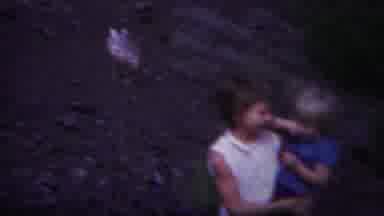 Yellowstone Wyoming (1967): Girl Wearing White Shirt Holds Small Child While Woman