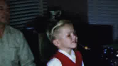 Paramus New Jersey (1959): Boy Wearing Red Vest Walks Past Trimmed Lit Christmas