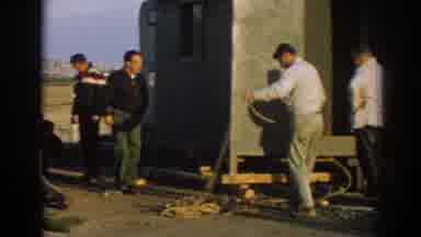 Ephesus Turkey (1962): Man Unravels A Long Cord Amongst A Group Of Men Outside