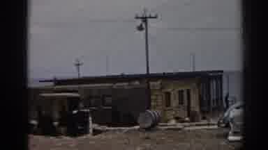 Ephesus Turkey (1962): View Of White Car Parked By Tan Building On A Clear Day
