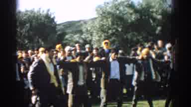 Izmir Turkey (1962): Five Men Wearing Grey Suits Dance With Linked Arms On A Sunny
