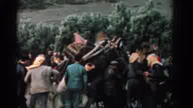 Izmir Turkey (1962): People Helping Loaded Camel Stand Up On A Clear Day
