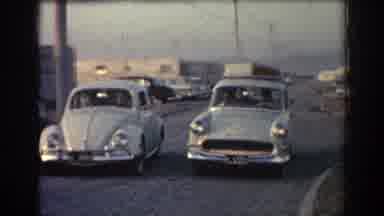 Rhodes Greece (1962): Old Slug Bug Car Drives Up And Stops Next To Another And Man