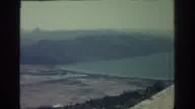 RHODES GREECE-1962: View Of Ocean Mountain And White Beach On A Cloudy Day