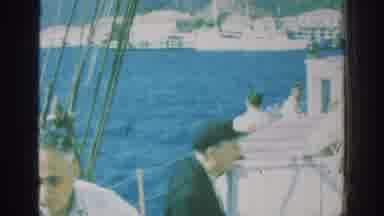 RHODES GREECE-1962: Men On A Sailboat During A Sunny Day In Rhodes Greece