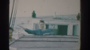 Rhodes Greece (1962): Woman Wearing Blue Shirt Waves At Camera While Riding On