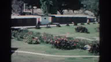 RHODES GREECE-1962: Suburban Garden With Flowerbeds And People Walking