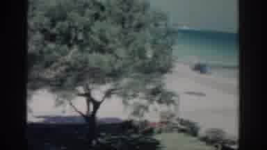 RHODES GREECE-1962: A Motorboat Rides On The Turquoise Sea