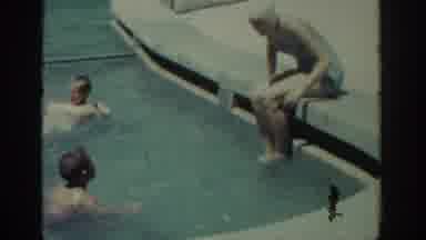 Rhodes Greece (1962): Woman Wearing Blue Swimwear Talks To Boy Jumping In Pool On