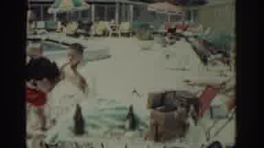 RHODES GREECE-1962: People Near Swimming Pool Men Applying Sunscreen