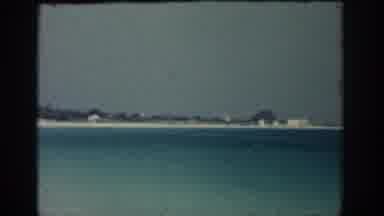RHODES GREECE-1962: View Of White Beach House Sandy Beach And Blue Ocean Water