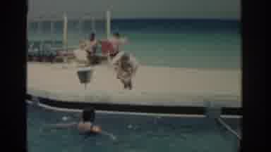 Rhodes Greece (1962): A Woman Swims In A Pool While A Child Puts On A Float Near