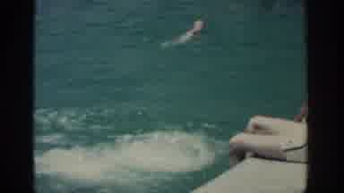 RHODES GREECE-1962: People At Swimming Pool With Children Jumping In And A Man
