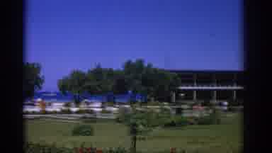 Rhodes Greece (1962): View Of Grey Building With Green Trees On A Sunny Day