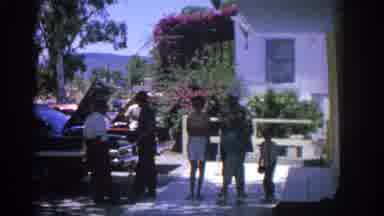Rhodes Greece (1962): Boy Wearing Green Shirt Waves To Camera On A Sunny Day